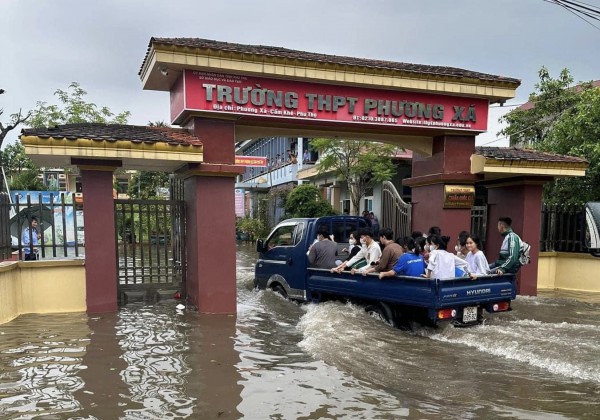 Cổng trường ngập sâu, công an dùng xe chuyên dụng đưa thí sinh vào phòng thi